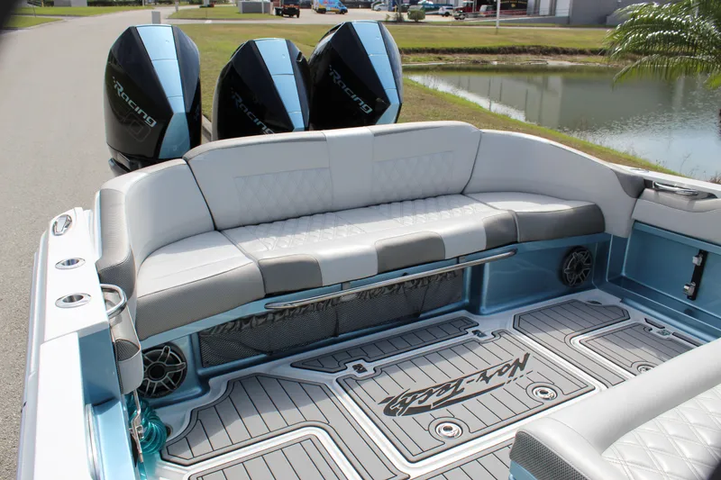 Slide: The Image of 2021 Nor-Tech 390 Sport Center Console boat with triple outboard engines and luxurious seating. - 39