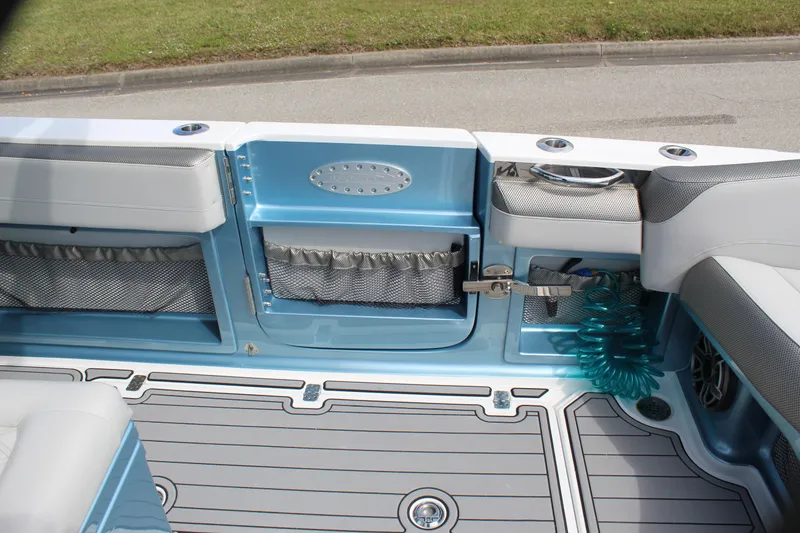 Slide: The Image of 2021 Nor-Tech 390 Sport Center Console interior with blue accents and storage compartments. - 40