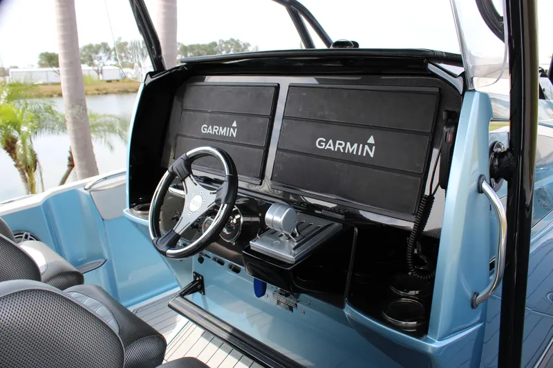 Slide: The Image of 2021 Nor-Tech 390 Sport Center Console with dual Garmin displays and sleek steering wheel. - 43