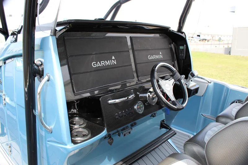 Slide: The Image of 2021 Nor-Tech 390 Sport Center Console dashboard with dual Garmin displays and steering wheel. - 44