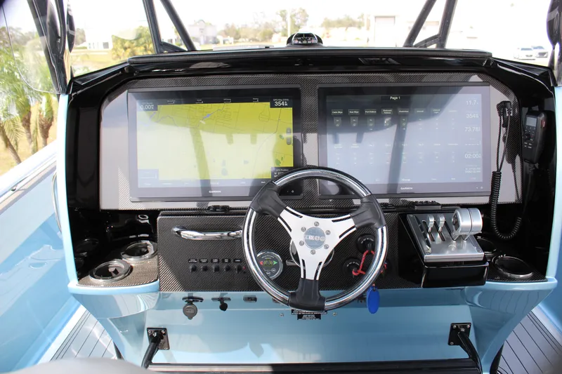 Slide: The Image of 2021 Nor-Tech 390 Sport Center Console dashboard with advanced navigation and control systems. - 50