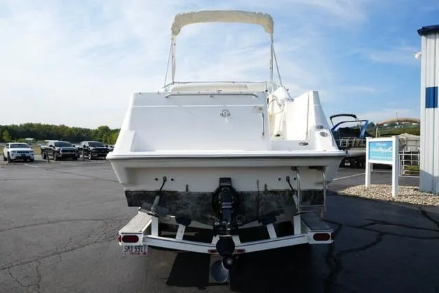 Slide: The Image of 1999 Bayliner 2655 Ciera Sunbridge on trailer, rear view, parked outdoors. - 10