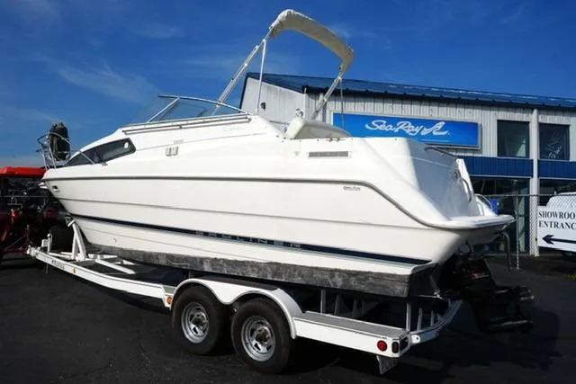 Slide: The Image of 1999 Bayliner 2655 Ciera Sunbridge on trailer, parked outside showroom. - 11