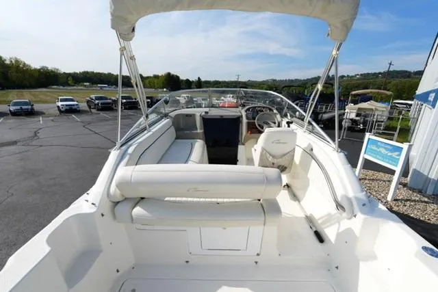 Slide: The Image of 1999 Bayliner 2655 Ciera Sunbridge boat interior with white seating and steering wheel. - 12