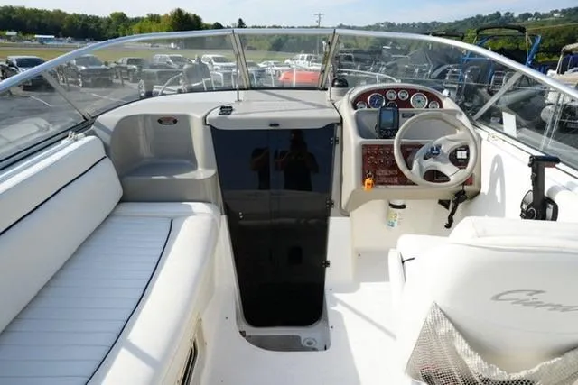 Slide: The Image of 1999 Bayliner 2655 Ciera Sunbridge cockpit with white seating and modern dashboard controls. - 13