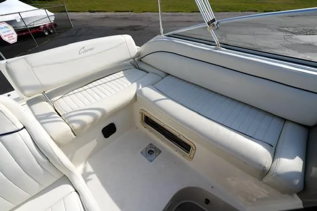 Slide: The Image of 1999 Bayliner 2655 Ciera Sunbridge boat interior with white cushioned seating. - 17