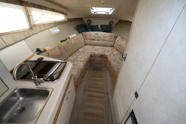 Slide: The Image of Interior of 1999 Bayliner 2655 Ciera Sunbridge with kitchenette and seating area. - 19