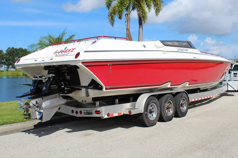 Slide: The Image of Red and white 2007 Fountain 42 Lightning speedboat on a trailer by a lake. - 10