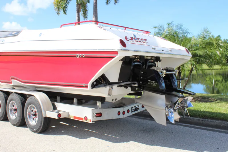 Slide: The Image of 2007 Fountain 42 Lightning boat on trailer, red and white, parked near palm trees. - 12