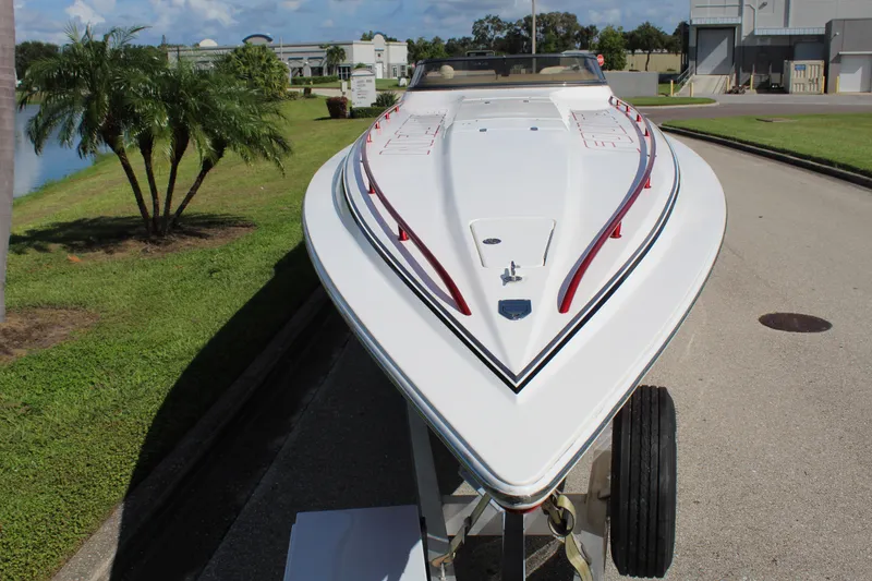 Slide: The Image of 2007 Fountain 42 Lightning speedboat on trailer, sleek design, white with red accents. - 19