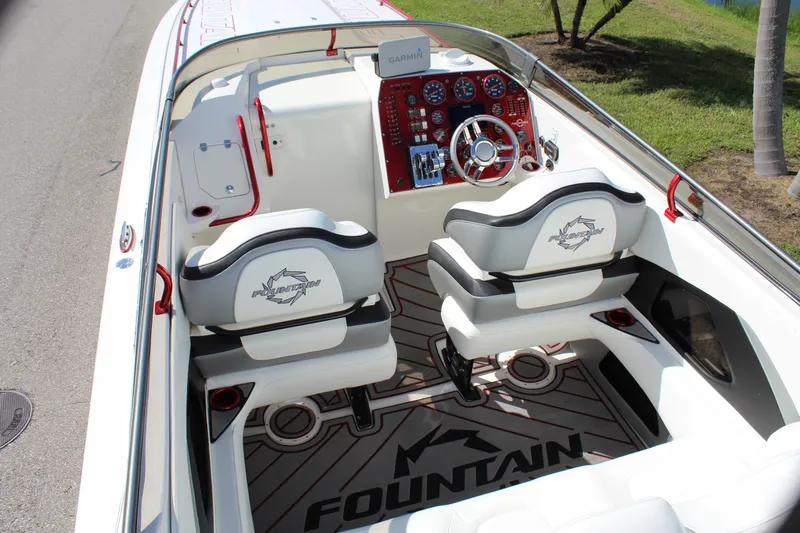 Slide: The Image of 2007 Fountain 42 Lightning boat interior with white seats and red dashboard. - 31