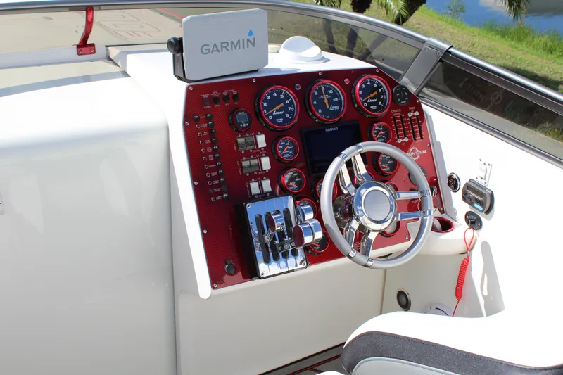 Slide: The Image of 2007 Fountain 42 Lightning boat dashboard with Garmin navigation system and red instrument panel. - 33