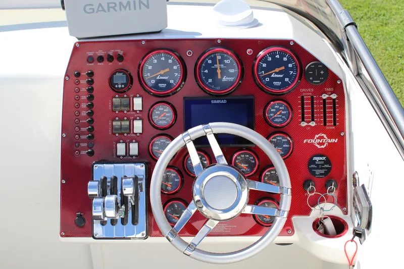 Slide: The Image of Dashboard of a 2007 Fountain 42 Lightning boat with steering wheel and gauges. - 34