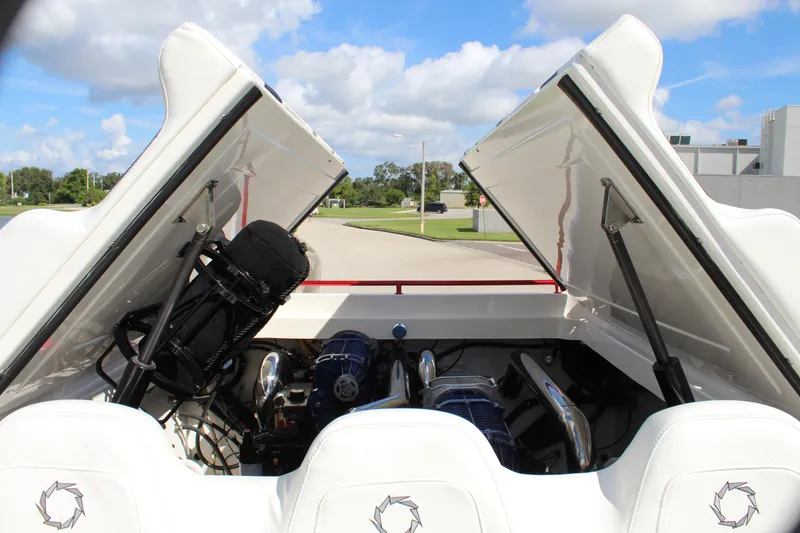 Slide: The Image of 2007 Fountain 42 Lightning boat engine compartment with open hatches under a blue sky. - 37