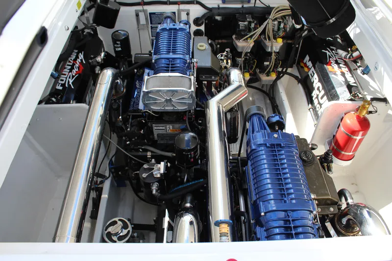 Slide: The Image of Engine compartment of a 2007 Fountain 42 Lightning boat, featuring dual blue superchargers. - 39