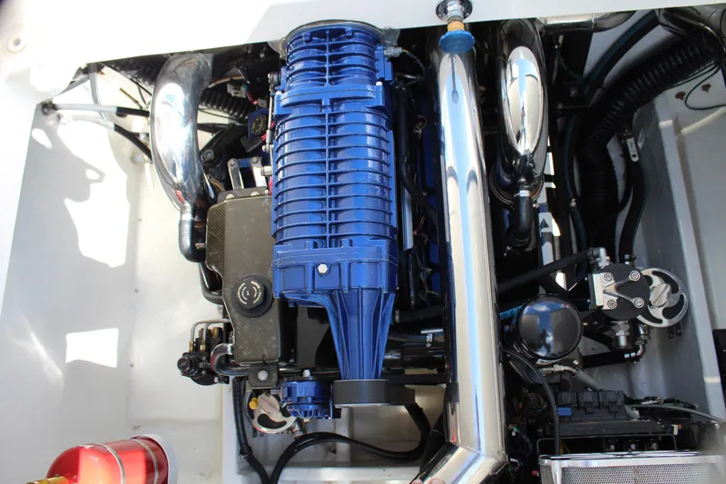 Slide: The Image of Engine of a 2007 Fountain 42 Lightning boat with blue and chrome components. - 43