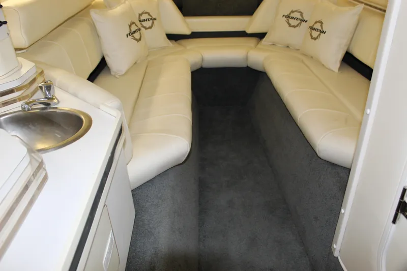 Slide: The Image of 2007 Fountain 42 Lightning cabin interior with white seating and compact sink area. - 51