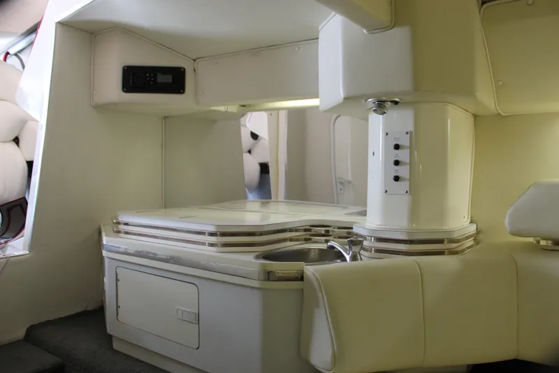 Slide: The Image of Interior of a 2007 Fountain 42 Lightning boat, featuring a compact kitchenette. - 57
