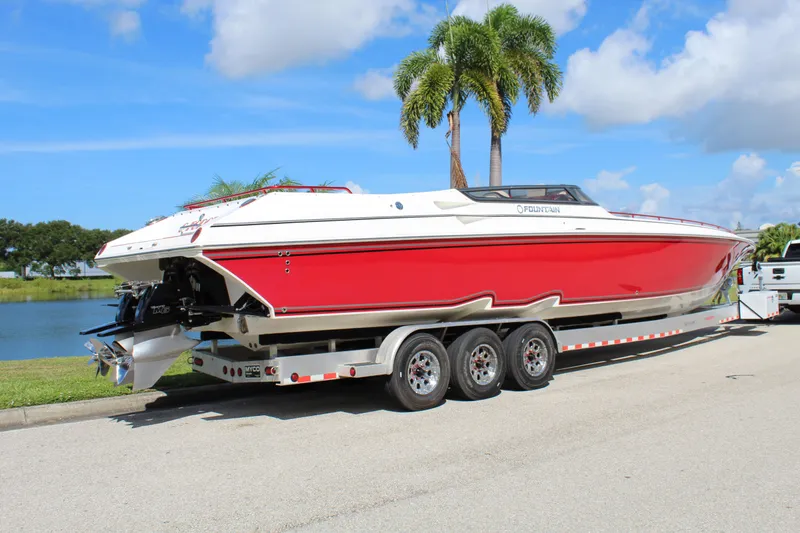 Slide: The Image of 2007 Fountain 42 Lightning speedboat on trailer, red and white design, parked near palm trees. - 9