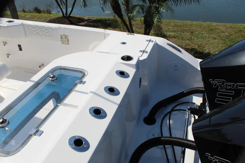 Slide: The Image of 2024 Fountain 32 NX boat interior with rod holders and engine view. - 27