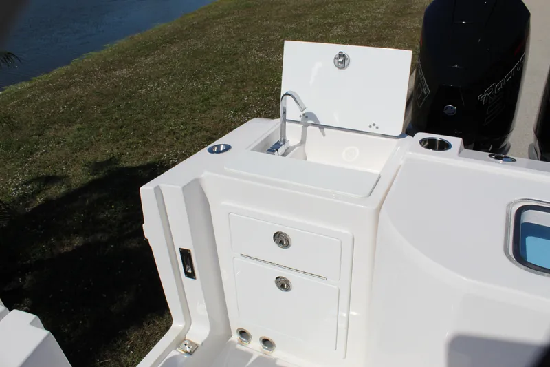 Slide: The Image of 2024 Fountain 32 NX boat sink and storage area, featuring sleek design and functionality. - 35