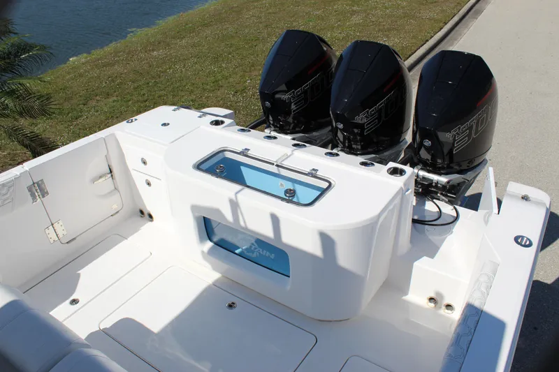 Slide: The Image of 2024 Fountain 32 NX boat with triple outboard engines, white deck, and livewell. - 37