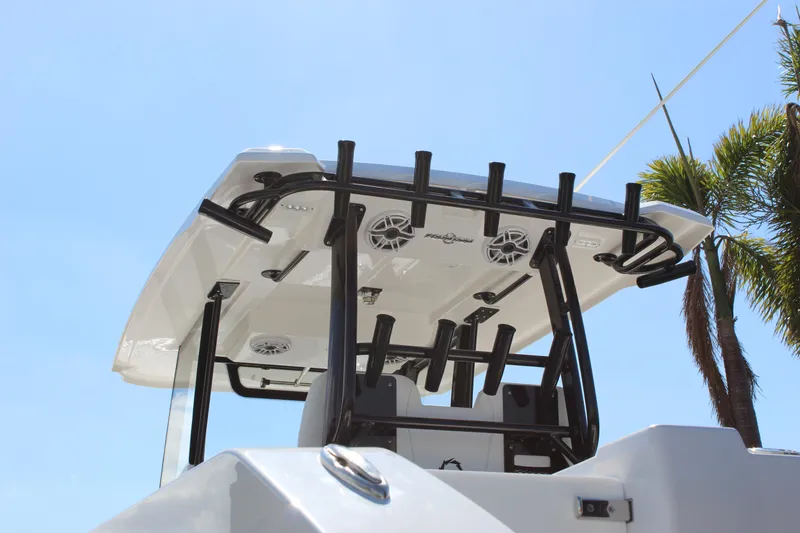 Slide: The Image of 2024 Fountain 32 NX boat with T-top and rod holders under clear blue sky. - 38