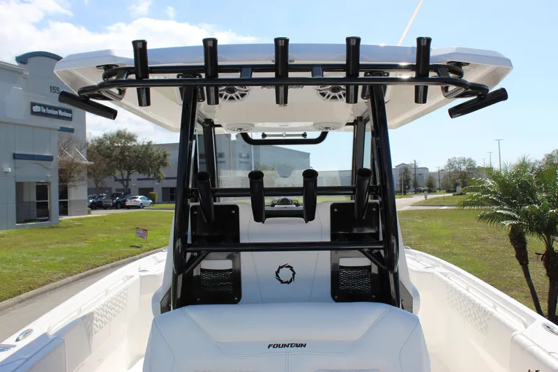 Slide: The Image of 2024 Fountain 32 NX boat with T-top and rod holders, docked outdoors. - 41