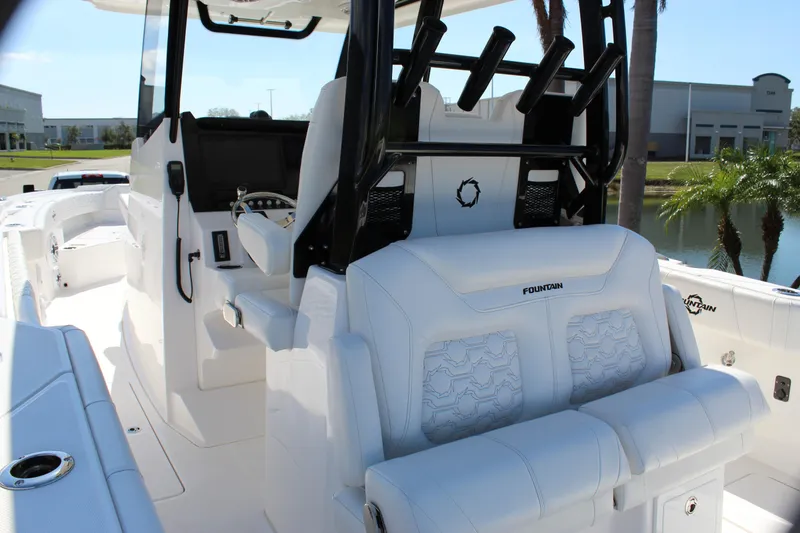 Slide: The Image of 2024 Fountain 32 NX boat interior with white seating and modern helm design. - 45