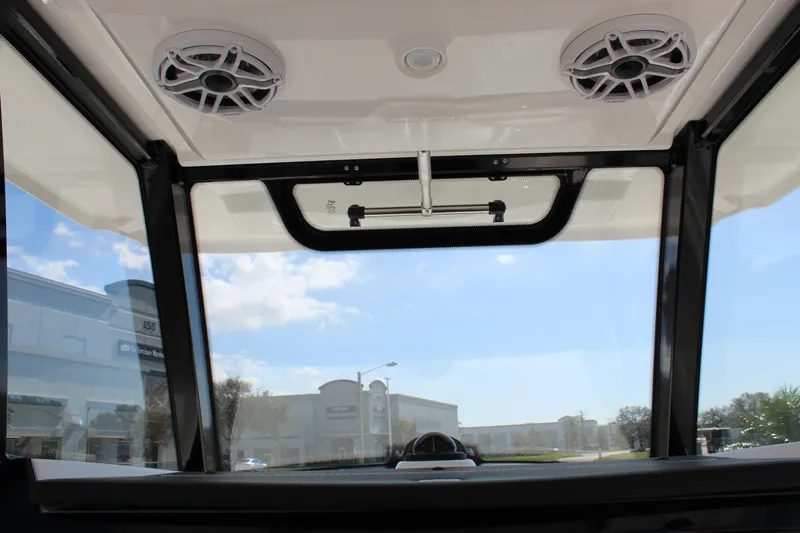 Slide: The Image of 2024 Fountain 32 NX boat interior view with speakers and clear sky. - 49