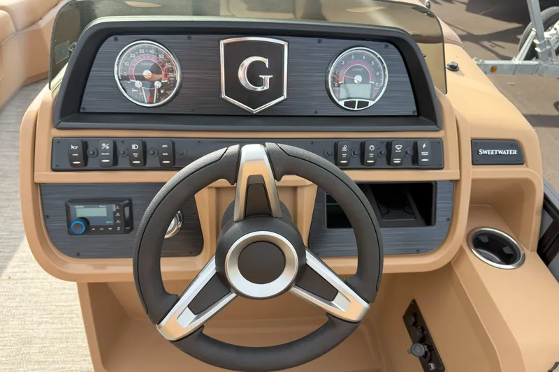Slide: The Image of Steering console of 2026 Godfrey SWEETWATER 2286 SFL boat with gauges and controls. - 11