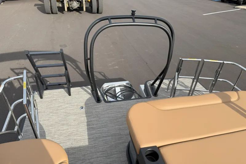 Slide: The Image of 2026 Godfrey SWEETWATER 2286 SFL boat deck with seating and ladder, parked on asphalt. - 14