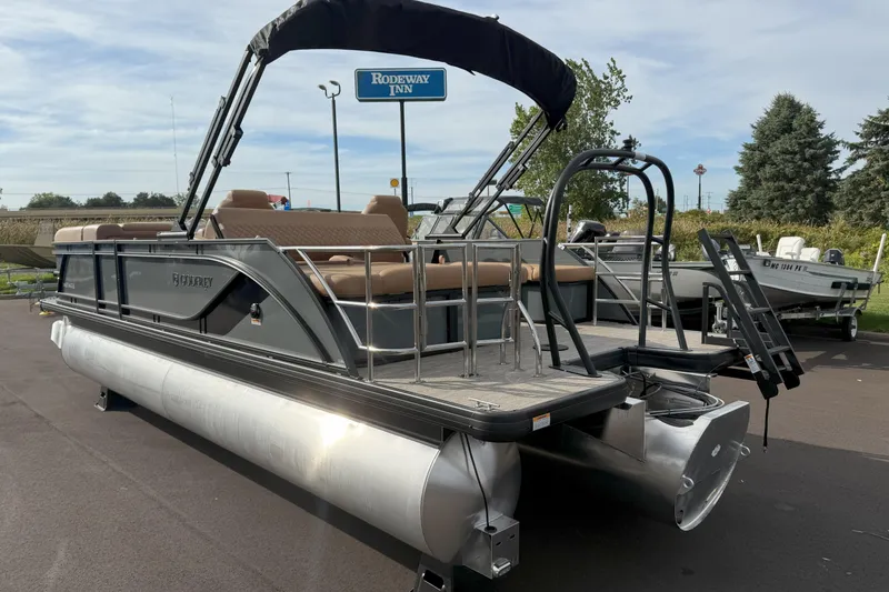 Slide: The Image of 2026 Godfrey SWEETWATER 2286 SFL pontoon boat with canopy, parked outdoors. - 15