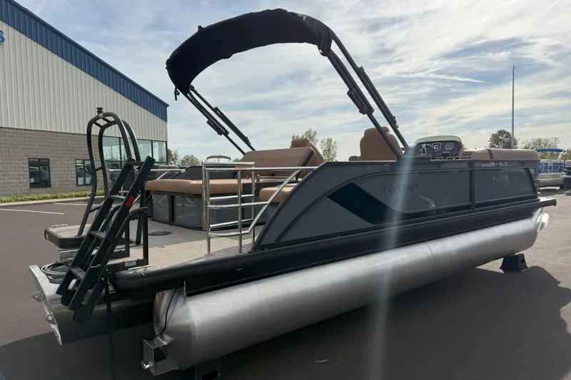 Slide: The Image of 2026 Godfrey SWEETWATER 2286 SFL pontoon boat with canopy, parked outdoors. - 3
