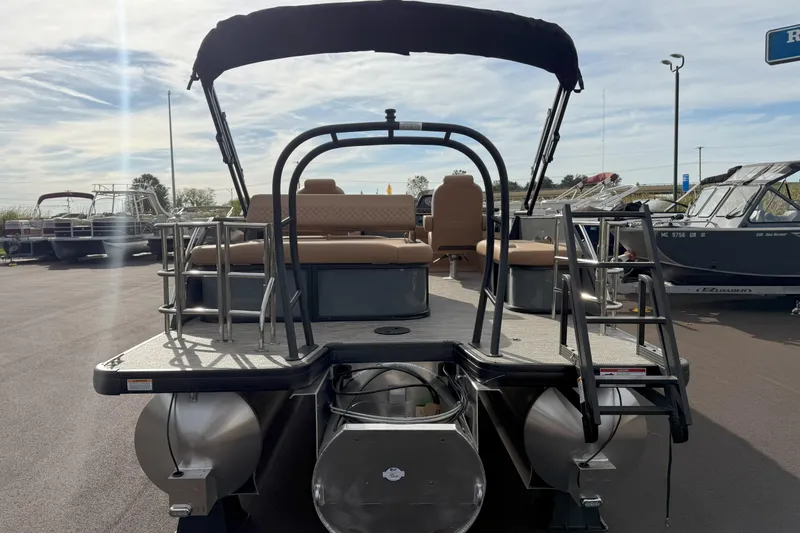 Slide: The Image of 2026 Godfrey SWEETWATER 2286 SFL pontoon boat, rear view, docked under clear sky. - 6