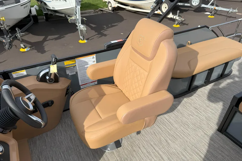 Slide: The Image of Captain's chair on 2026 Godfrey SWEETWATER 2286 SFL pontoon boat, featuring tan upholstery. - 9