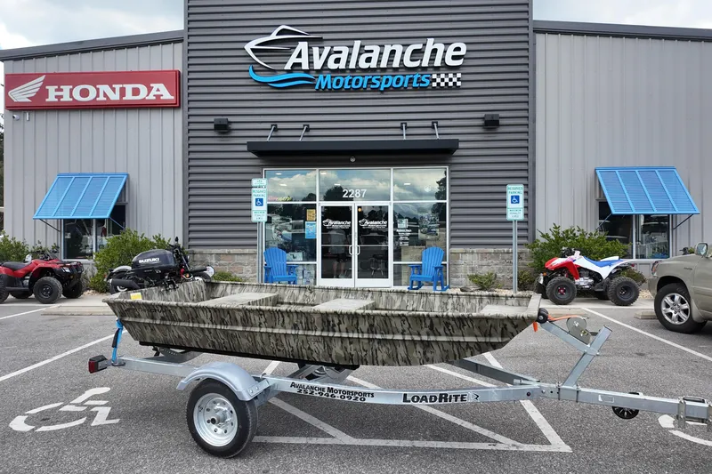 Slide: The Image of 2026 Starcraft JON 1032 boat on trailer outside Avalanche Motorsports dealership. - 1