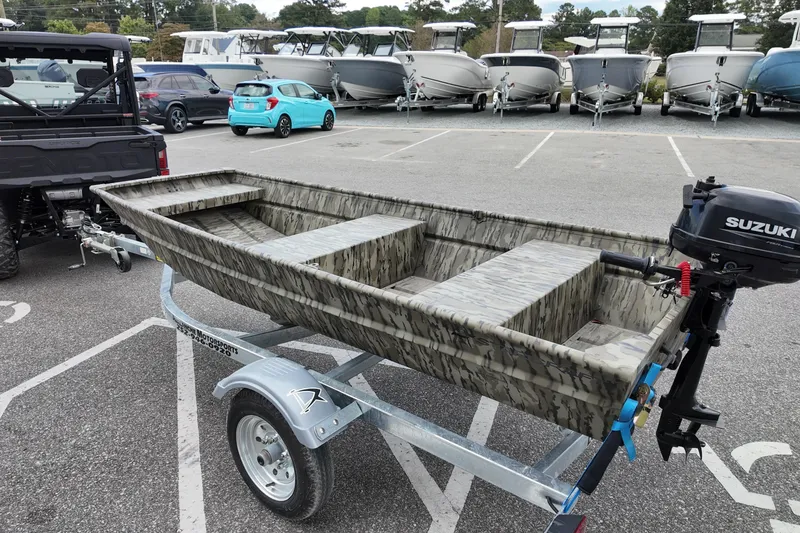 Slide: The Image of 2026 Starcraft JON 1032 boat on trailer with Suzuki outboard motor. - 3