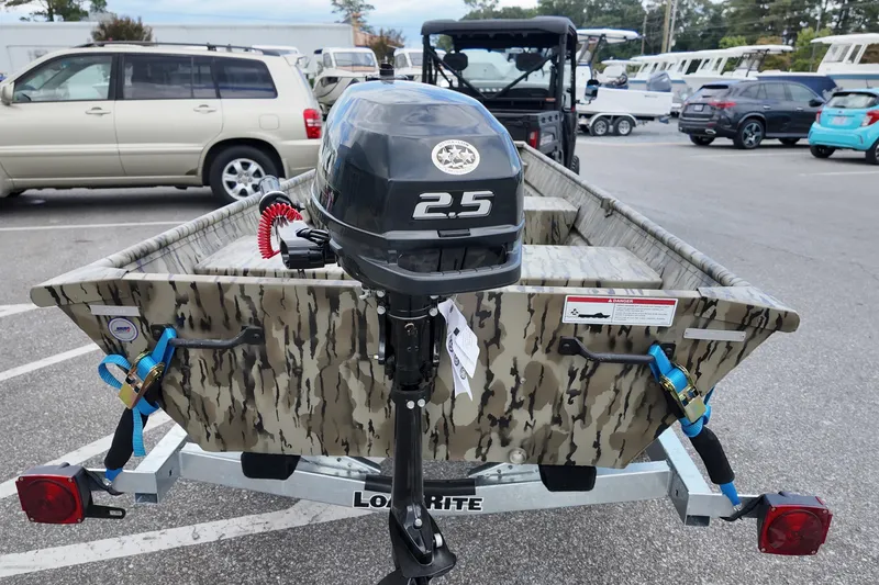 Slide: The Image of 2026 Starcraft JON 1032 boat with 2.5 HP motor on trailer in parking lot. - 4