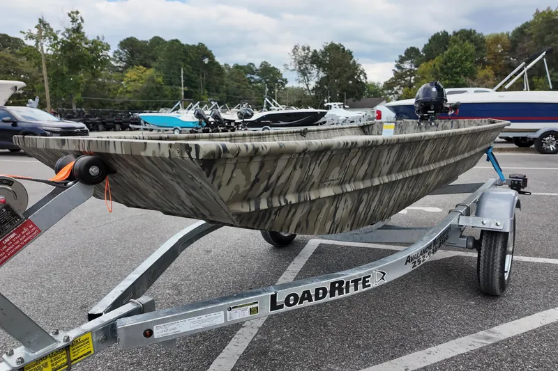 Slide: The Image of 2026 Starcraft JON 1032 boat on Load Rite trailer in parking lot. - 5