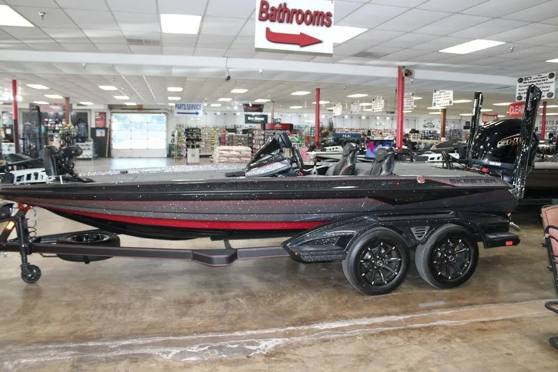 Slide: The Image of 2025 Skeeter FXR20 Limited boat displayed in showroom, featuring sleek black and red design. - 3