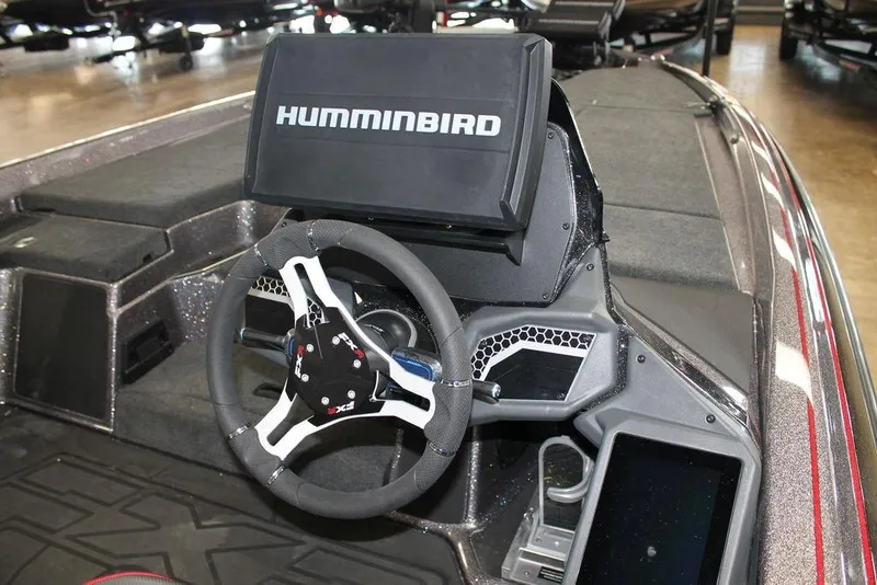 Slide: The Image of 2025 Skeeter FXR20 Limited boat dashboard with Humminbird display and steering wheel. - 9