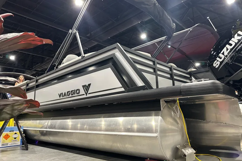 Slide: The Image of 2026 Viaggio Lago X20U pontoon boat displayed indoors with Suzuki engine. - 4