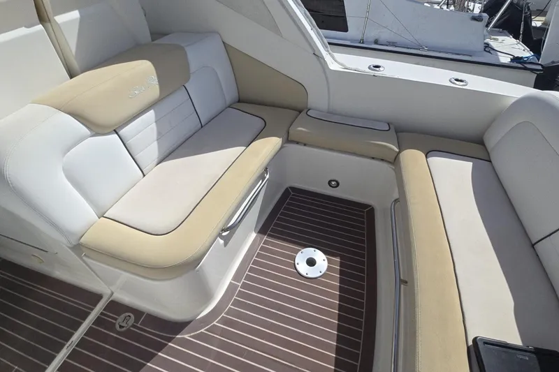 Slide: The Image of Interior seating of 2010 Sea Ray 350 Sundancer with beige and white upholstery. - 15