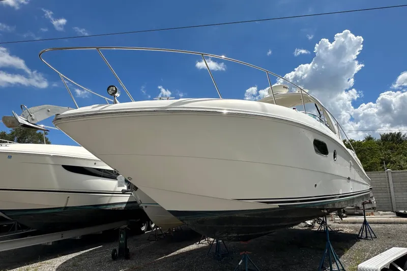Slide: The Image of 2010 Sea Ray 350 Sundancer boat on stands under a clear blue sky. - 6