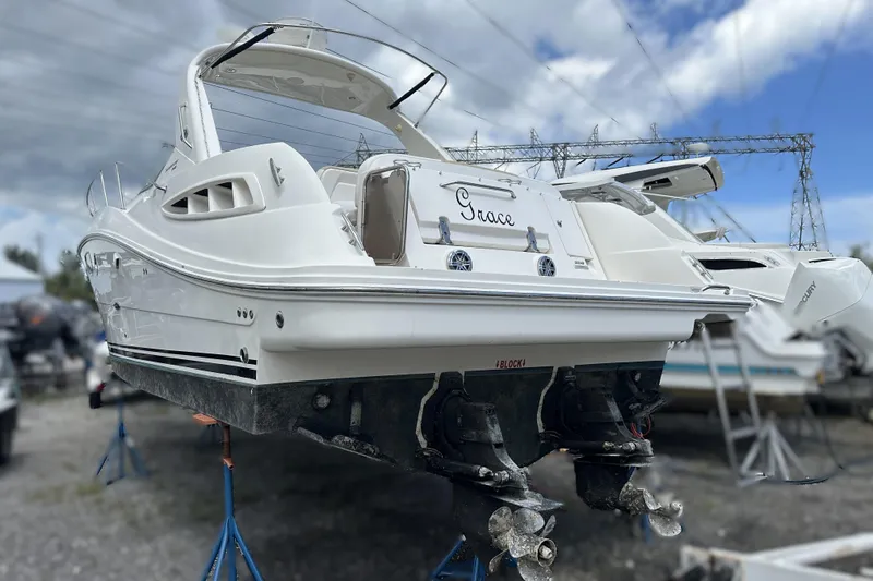 Slide: The Image of 2010 Sea Ray 350 Sundancer boat on stands, rear view, cloudy sky background. - 7