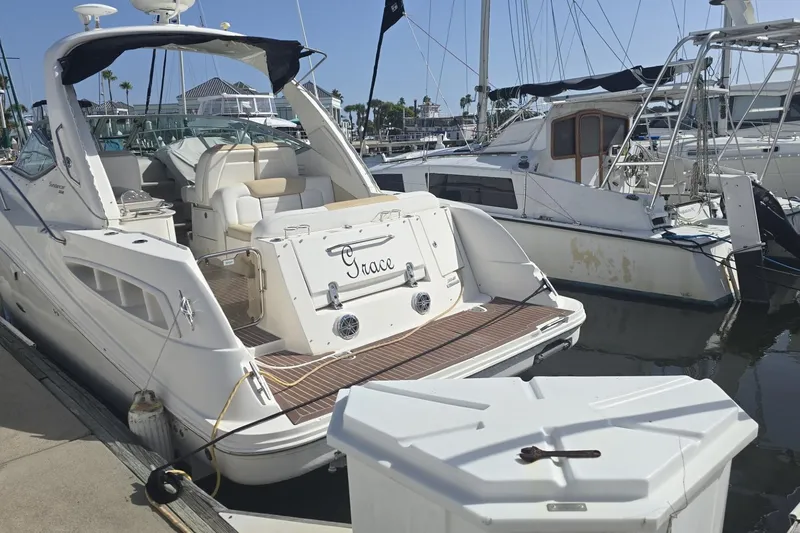 Slide: The Image of 2010 Sea Ray 350 Sundancer yacht docked at marina, featuring spacious deck and elegant design. - 9