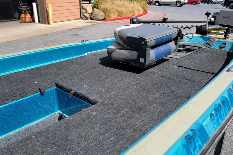 Slide: The Image of 1995 Champion 181 SC boat interior with folded seat and carpeted deck. - 7