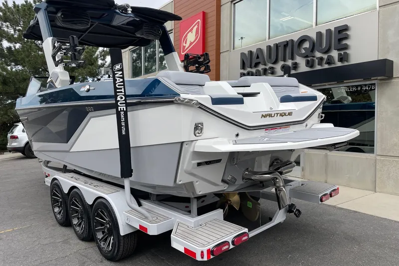 Slide: The Image of 2026 Nautique Super Air Nautique G25 boat on trailer at dealership. - 3