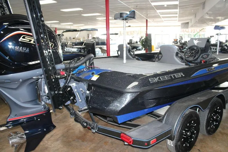 Slide: The Image of 2026 Skeeter ZXE21 boat with Yamaha engine, displayed indoors on a trailer. - 2